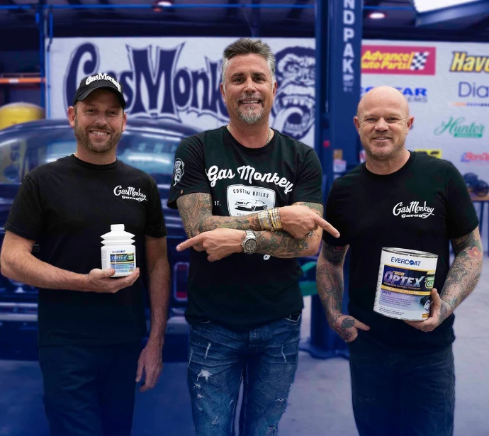 Three men posing with evercoat products
